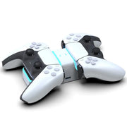 PS5 controller charging base, black and white finish, with charge status light signals.